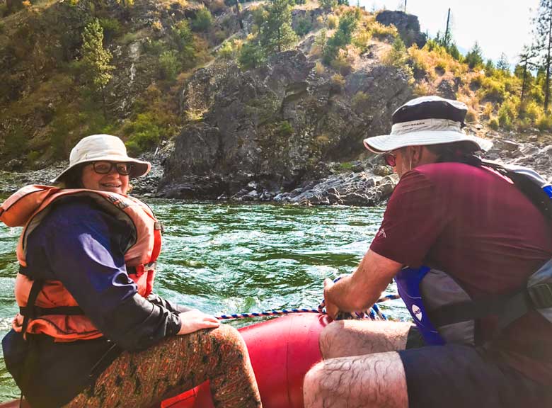 Couple rafting during Main Salmon River whitewater rafting vacation in Idaho.