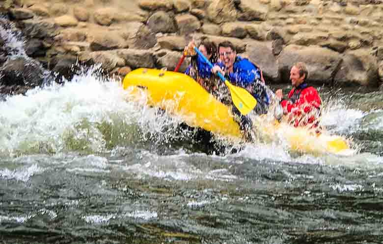 Guests with a river guide during a guided whitewater rafting trip on the Kern River, Kernville California.